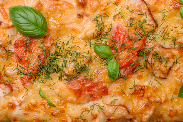 Delicious oven fresh flatbread pizza with cheese, tomatoes, sausage, salt and spices