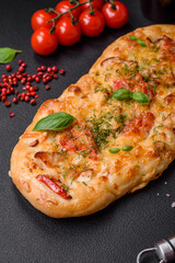 Delicious oven fresh flatbread pizza with cheese, tomatoes, sausage, salt and spices