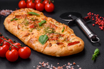 Delicious oven fresh flatbread pizza with cheese, tomatoes, sausage, salt and spices
