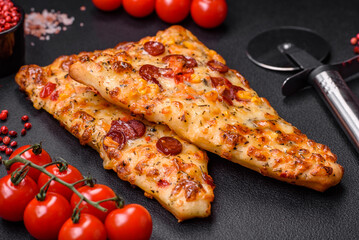 Delicious oven fresh flatbread pizza with cheese, tomatoes, sausage, salt and spices