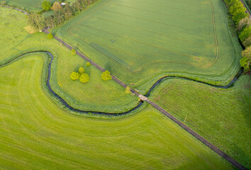 Aerial view of a river winding through the fields in the countryside in Kent, UK - obrazy, fototapety, plakaty