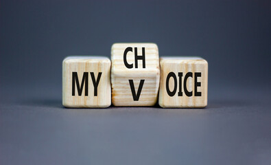 My voice and choice symbol. Businessman turns wooden cubes and changes the concept word my choice...