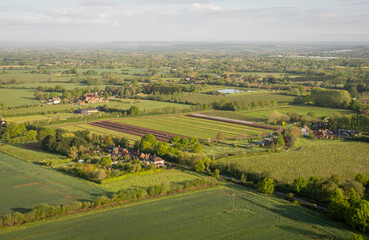 Aerial view of a farm and surrounding fields in the countryside in Kent, UK