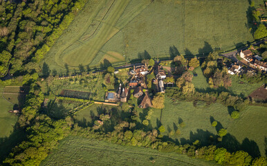 Aerial view of a farm with oast houses in the countryside in Kent, UK