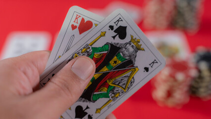 playing cards and poker chips on red background