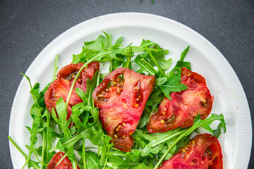 tomato arugula salad healthy meal food snack on the table copy space food background rustic top view 