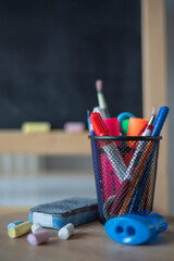 Supplies in front of the chalk board. back to school concept 