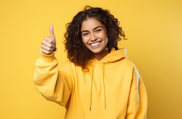 portrait of a happy young woman on a yellow background - Powered by Adobe