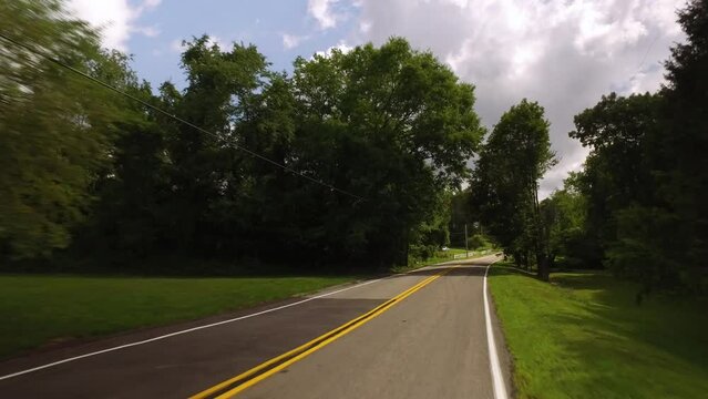 A driver's perspective driving on a Pennsylvania countryside road outside of Pittsburgh.  	