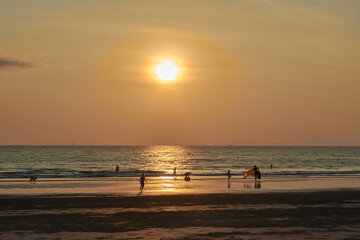 sunset on the beach in thailand with family