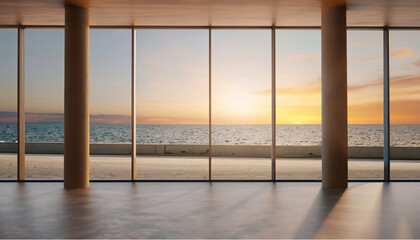 Large windows in a room overlooking the sunset on the beach