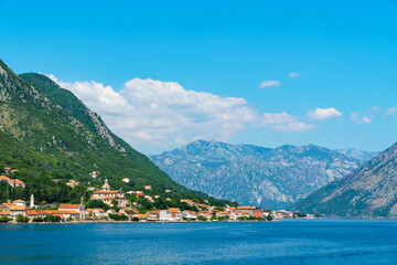 Fototapeta na wymiar seascapes, a view of the Bay of Kotor during a cruise on a ship in Montenegro, a bright sunny day, mountains and small towns on the coast, the concept of a summer trip