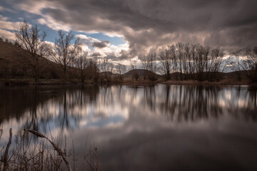 Perfectly symmetric clouds and trees reflections on Colfiorito Umbria swamp - 629333091
