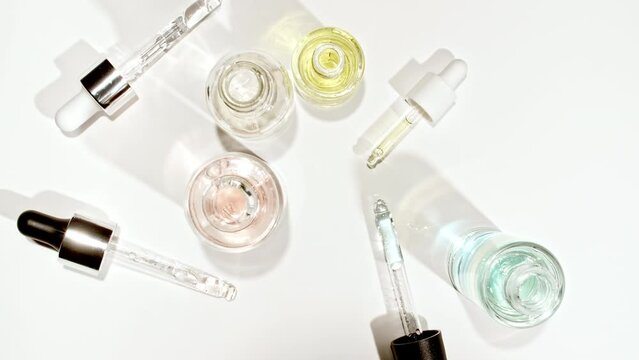 Cosmetic pipette with drops of oil close up into bottle. Extract, aromatic, essential oil. Cosmetics oils based on natural ingredients. Natural cosmetics production for hair and skin care. 4k 