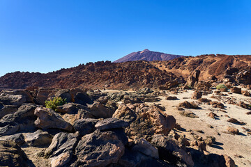 Landscape in the mountains with a volcano. The terrain resembles the surface of the planet Mars