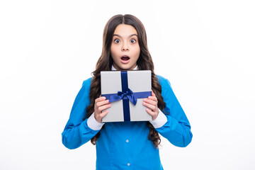 Fototapeta premium Excited kids face. Teenager child with present box. Teen girl giving birthday gift. Present, greeting and gifting concept. Amazed expression, cheerful and glad.