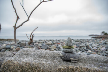 Stacked cairn stone zen sculpture on New England beach