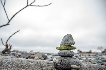 Stacked cairn stone zen sculpture on New England beach