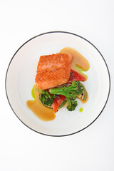 Grilled salmon fillet with vegetables. Healthy food. Healthy breakfast. Grilled vegetables with fish. Isolated object. Top view. Copy space.Vertical photo.