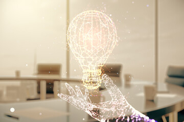 Abstract virtual light bulb hologram on a modern boardroom background, idea concept. Multiexposure
