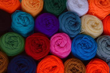 Blurry background of colorful knitting. View from above of colorful knitting.