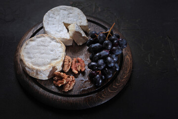 Camembert cheese on wooden board. Cheese with white mold. Natural product made from milk.Copy space.