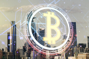 Virtual Bitcoin hologram on New York city skyline background. Multiexposure