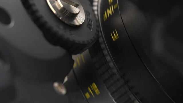 Close up of the lens with the Follow Focus motorized system. The process of adjusting focal length by using a professional wireless system for focus puller.