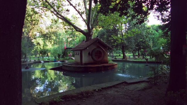 Watermill in a pond in a forest of pines, vintage mood.