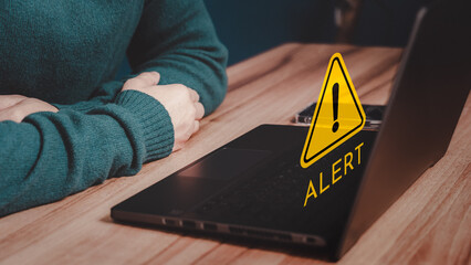 Man working on computer laptop with octagonal shape warning sign for notification error. Technology...