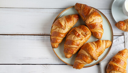 traditional breakfast with fresh croissants and white wooden background, top view, horizontal