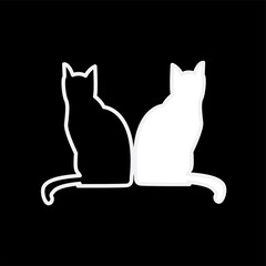 a pair of black and white cats