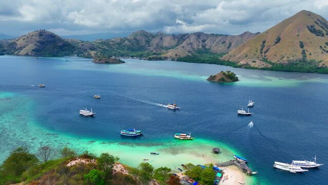 aerial view of Komodo islands, exotic travel destination in Indonesia. Tropical summer holiday. Cruise boat vacation. Cinematic drone flight Flores, Indonesia