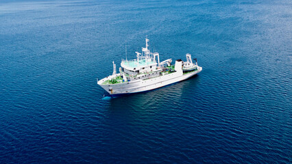 Ship in the open sea. Research vessel on a calm open sea.