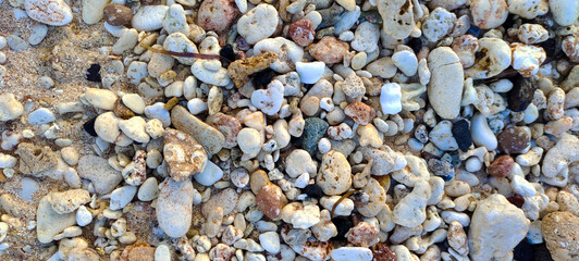 ASIA, INDONESIA June 2023, small rocks on white sand