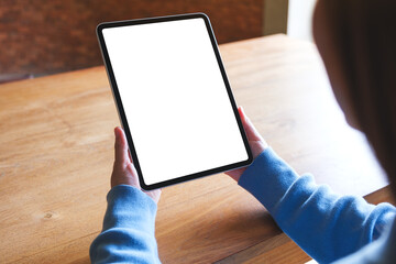 Mockup image of a woman holding digital tablet with blank white desktop screen