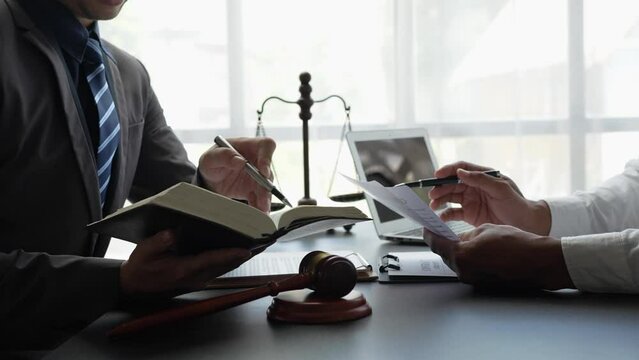 Attorneys or lawyers who are reading the statute of limitations Consultation between male lawyers and business clients, tax and legal and legal services firms.