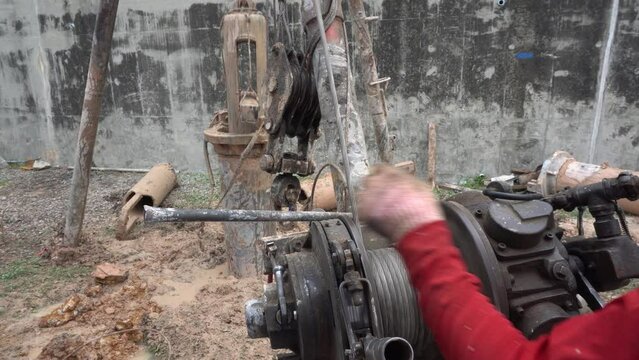 Tripod piling rig machine is drilling holes in the construction site for concrete piles work and reinforced elements cast into drilled holes to be the foundation.