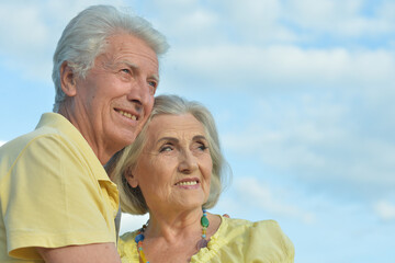 Beautiful Caucasian aged couple outdoors on a sky background