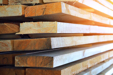 New planed wooden boards stacked in sawmill. Procurement and sale of building material. Dry wood. Woodworking. Background.