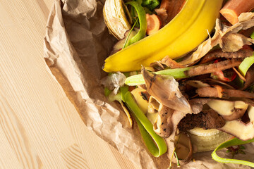 Food organic waste on eco friendly parchment paper, fruit and vegetable peel, garbage sorting and...