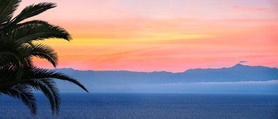 Banner of sunset over sea in Corfu island in Greece. Summer time and mood. Beautiful vibrant evening. Copy space.