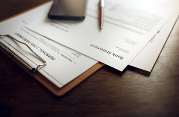 Personal loan document with bank statement, mobile phone and pen on desk office prepared for signing loan documents for business, image for business background