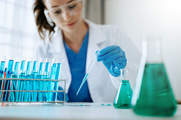 Modern medical research laboratory. female scientist working with micro pipettes analyzing...