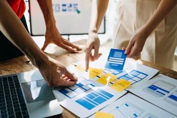  UX developer and ui designer brainstorming about mobile app interface wireframe design with...