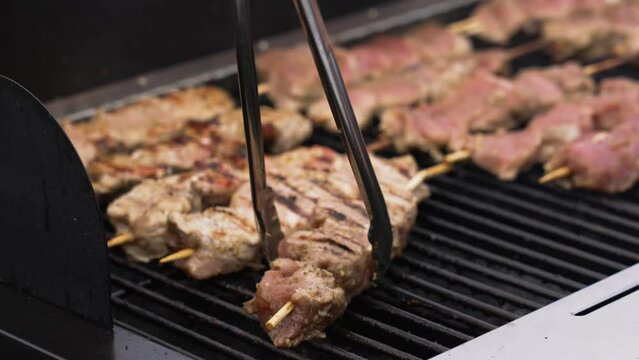Turning over the meat in slow motion.