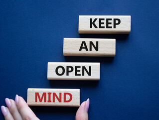 Keep an open mind symbol. Wooden blocks with words Keep an open mind. Businessman hand. Beautiful grey green background. Business and Keep an open mind concept. Copy space.