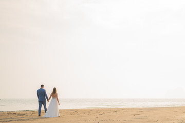 couple walking on beach wedding