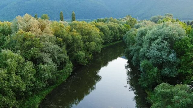 Slow Aerial Forward Movement Above Beautiful Bosnian River Surrounded by Trees in 4K