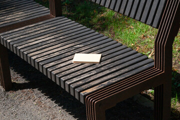 Forgotten passport on the wooden bench in the city park. lost document in the park.